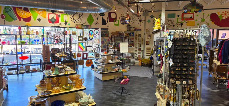 Colorful vintage glassware and atomic-age mural inside the store