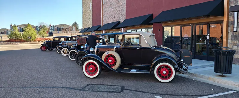 Classic cars lined up outside Modern Vintage Marketplace